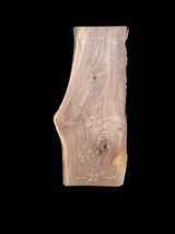 A short walnut slab with a black background.