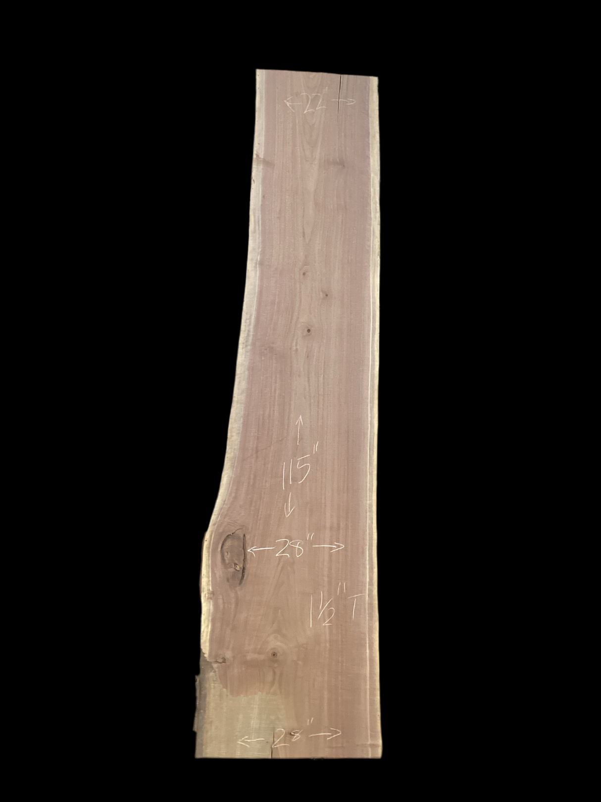 Large walnut wood slab with a black background.