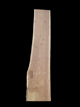 Large walnut wood slab with a black background.