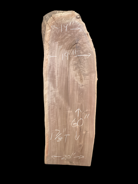 A short walnut slab with a black background.