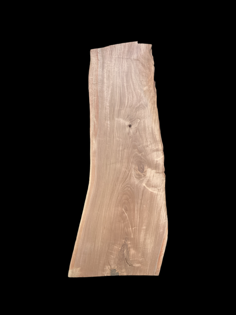 A large walnut slab with a black background.