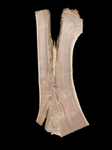 A short, irregular shaped walnut slab with a black background. 
