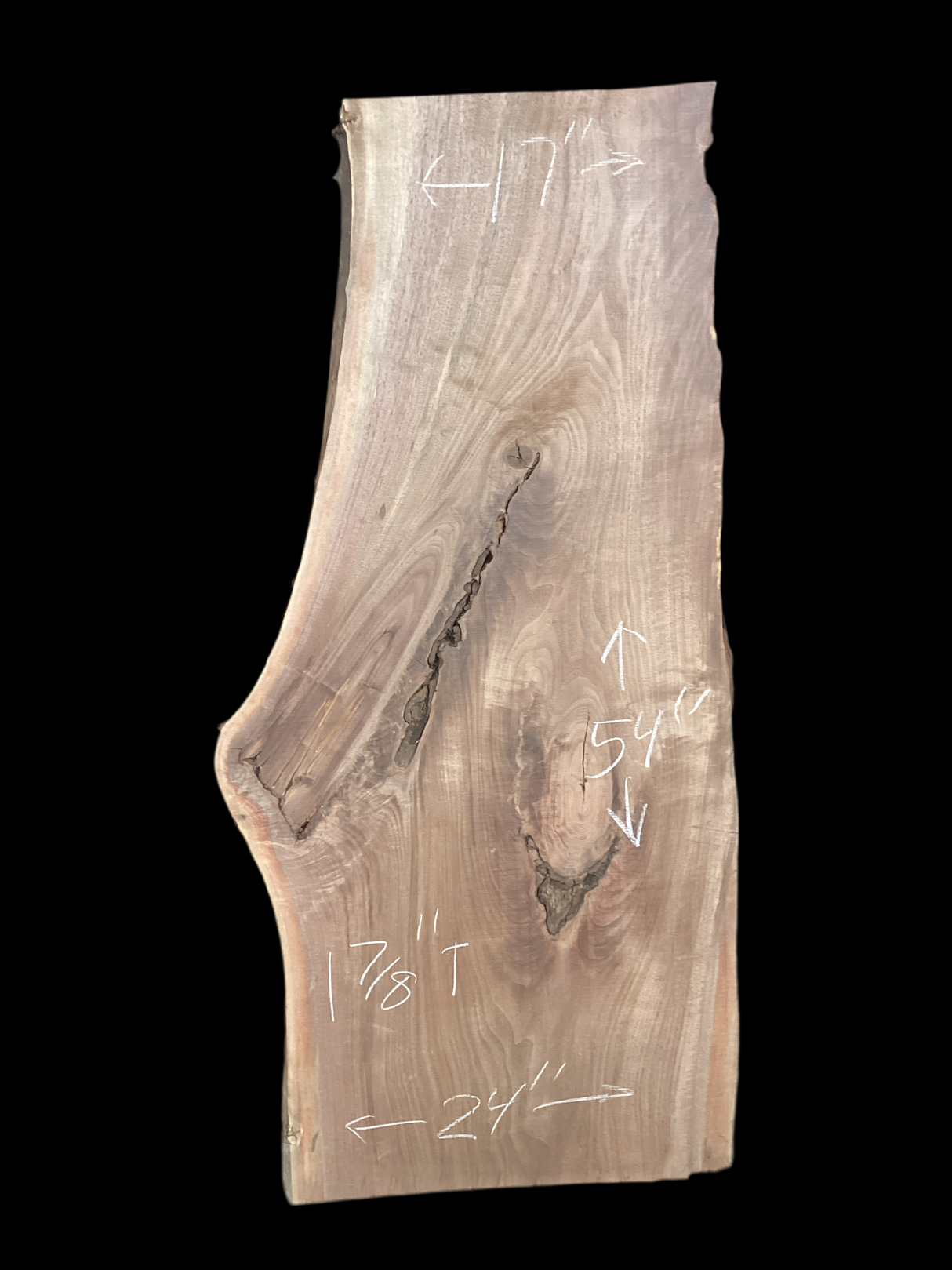 A large walnut slab with a black background.