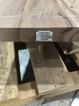 A tapered walnut slab with a visible natural limb hole or void, marked with a QR label on the edge.