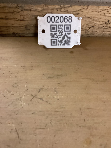 QR code with the sku 2068 against a brick wall.